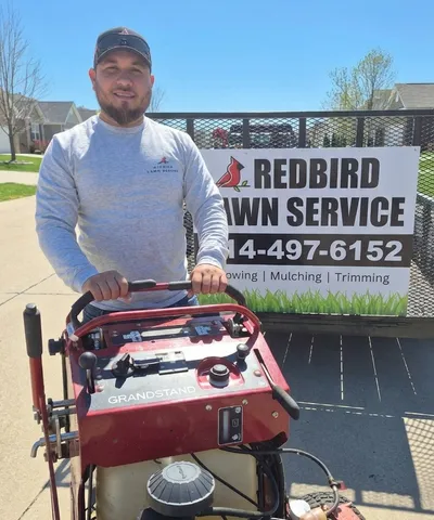 Alberto Murillo, owner of Redbird Lawn Service, with professional lawn care equipment in Wentzville, MO